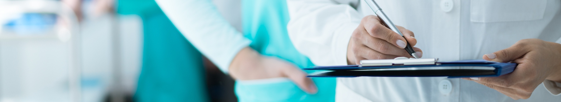 Cropped image of arms of medical staff, doctor holding clipboard